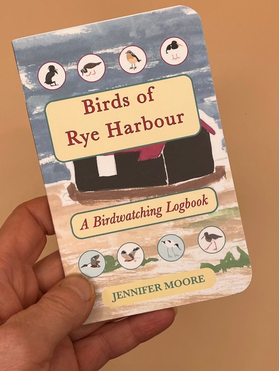 Hand holding a Birds of Rye Harbour birdwatching logbook