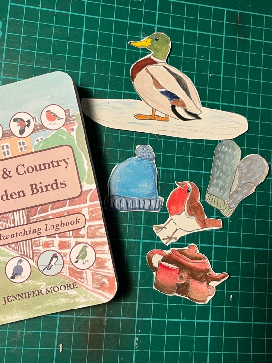 collage pieces and a birdwatching logbook